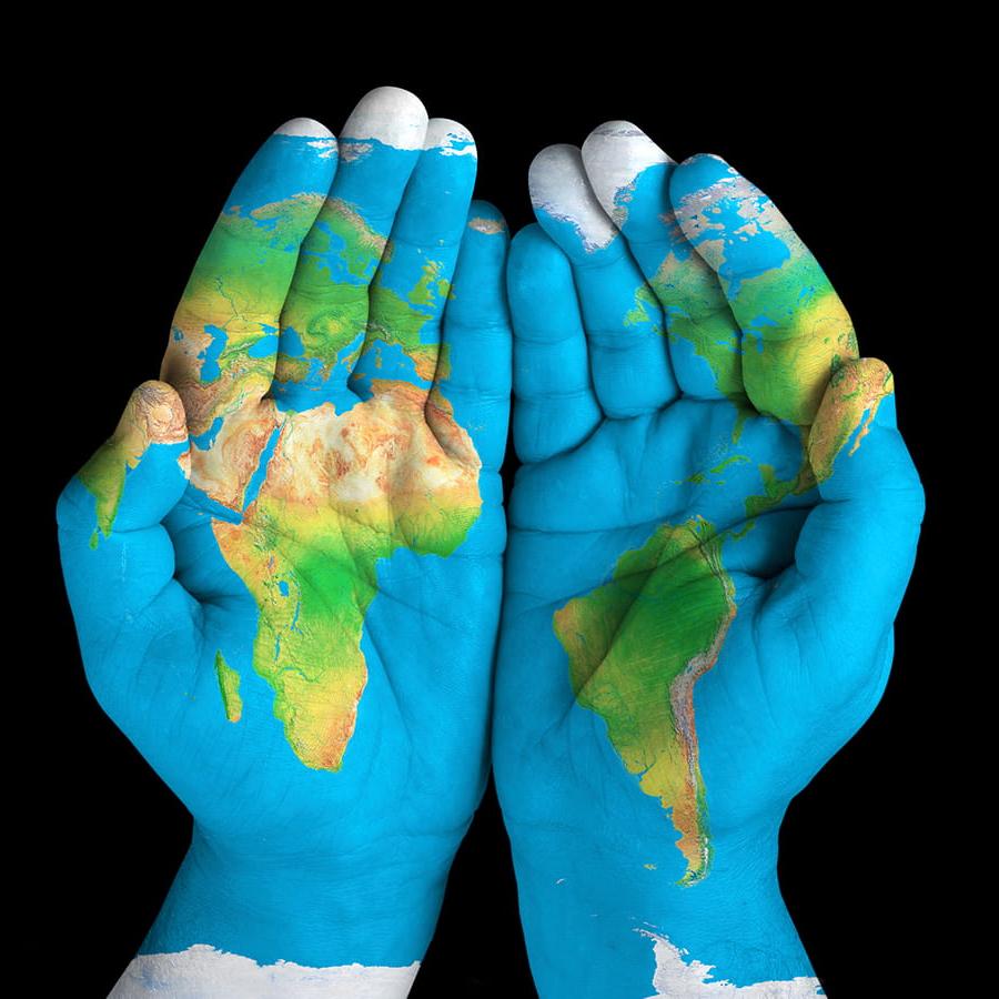 Map of earth superimposed on pair of hands